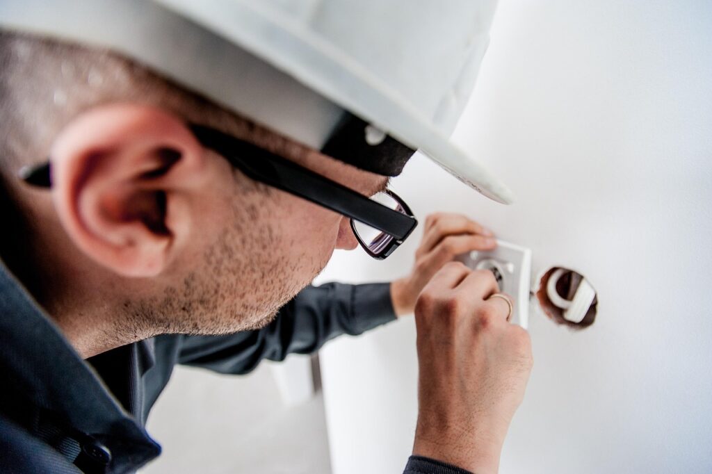 Electrician installing outlet